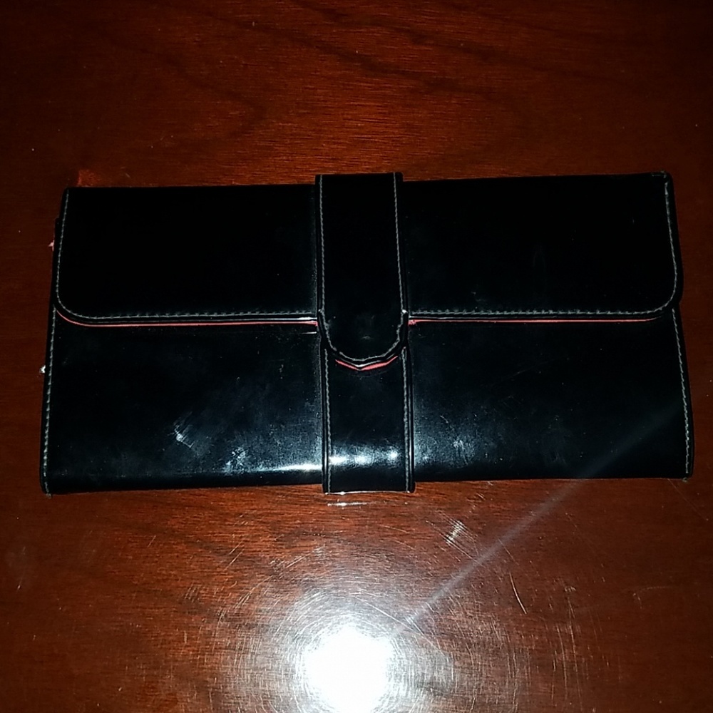 Holds cash travel makeup and phone